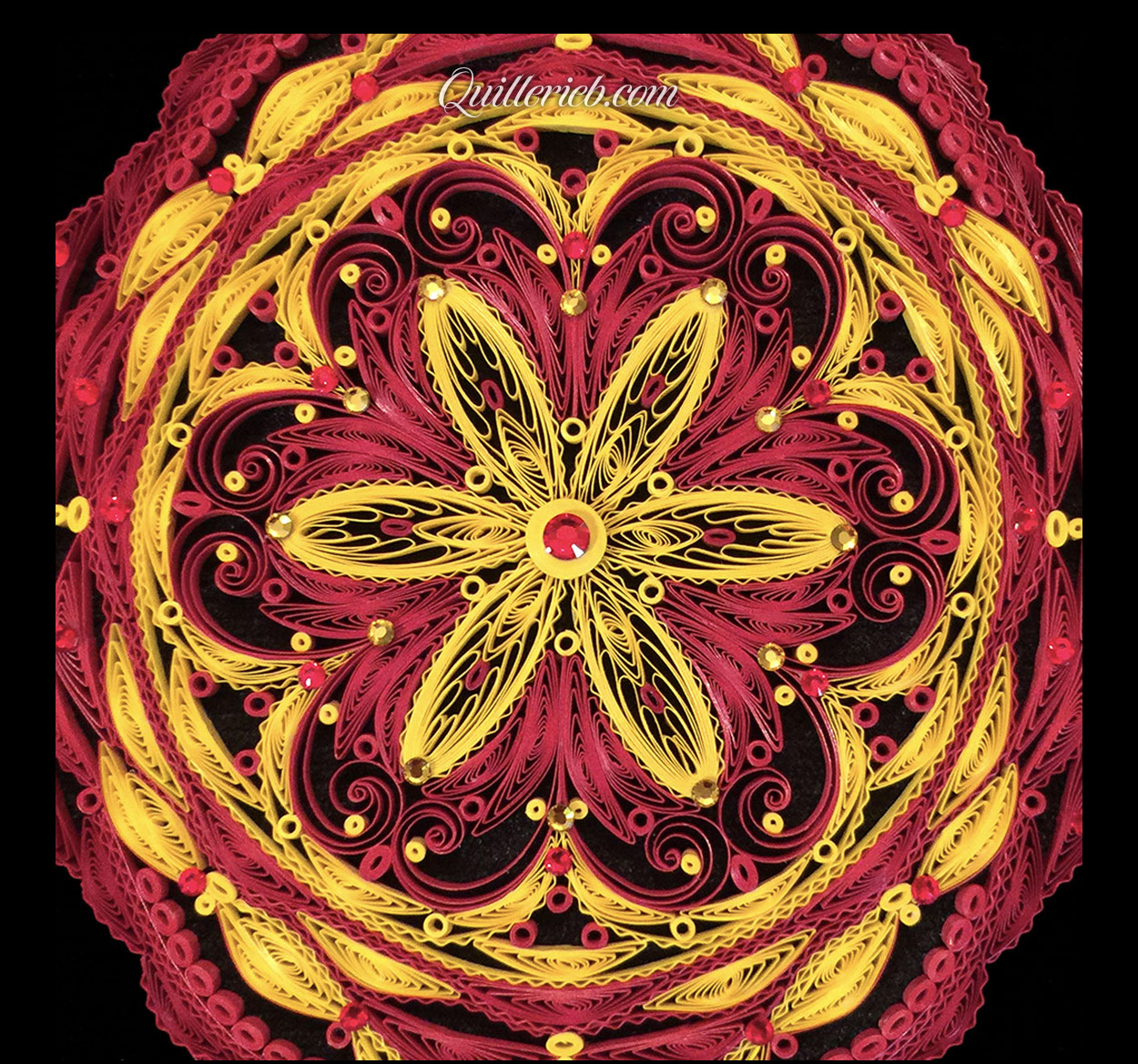 Red and Yellow inspired quilling with diamond design close up.