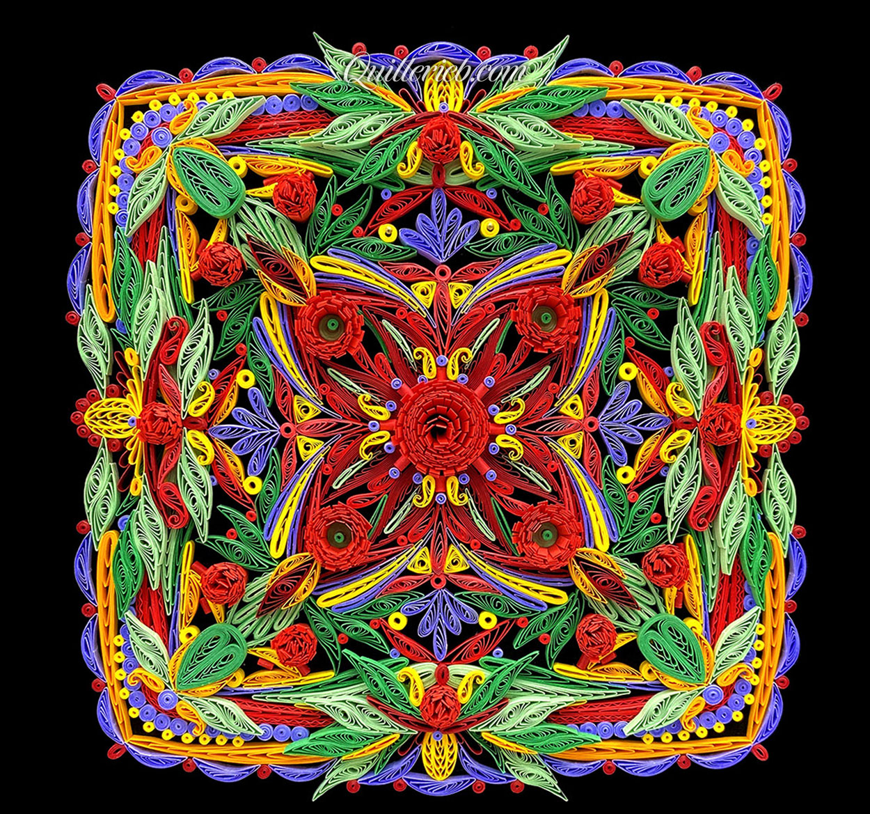 Square-shaped quilling in reds, yellows, greens and purples full view.