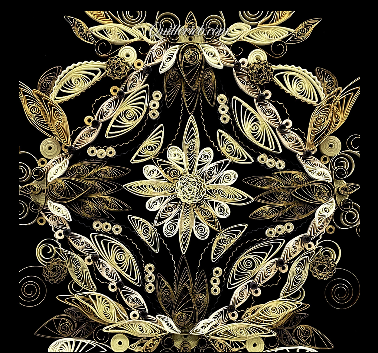 Free-form quilling in creams and muted greens centered close-up view.