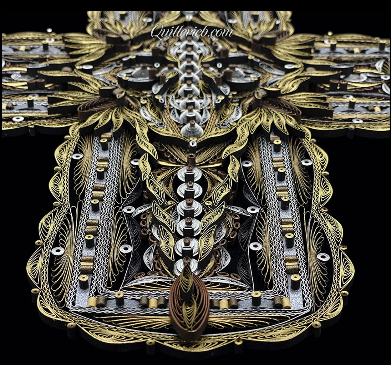 Image of quilled cross gold and silver slanted back perspective.