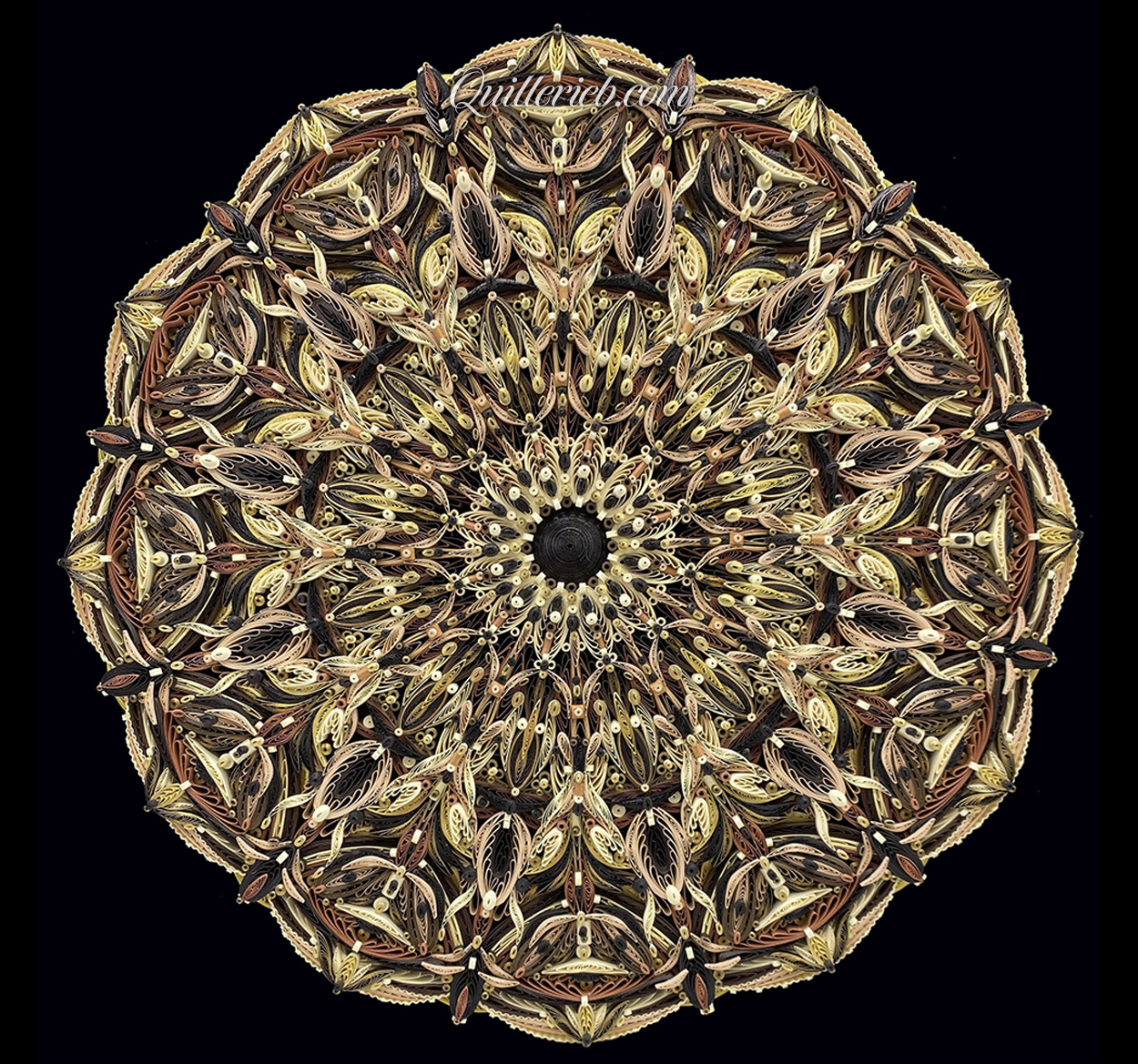 Circular quilled design in brown tones full view.