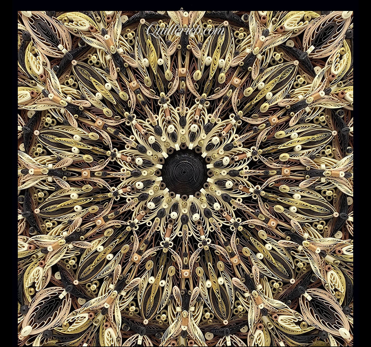 Circular quilled design in brown tones close-up view.