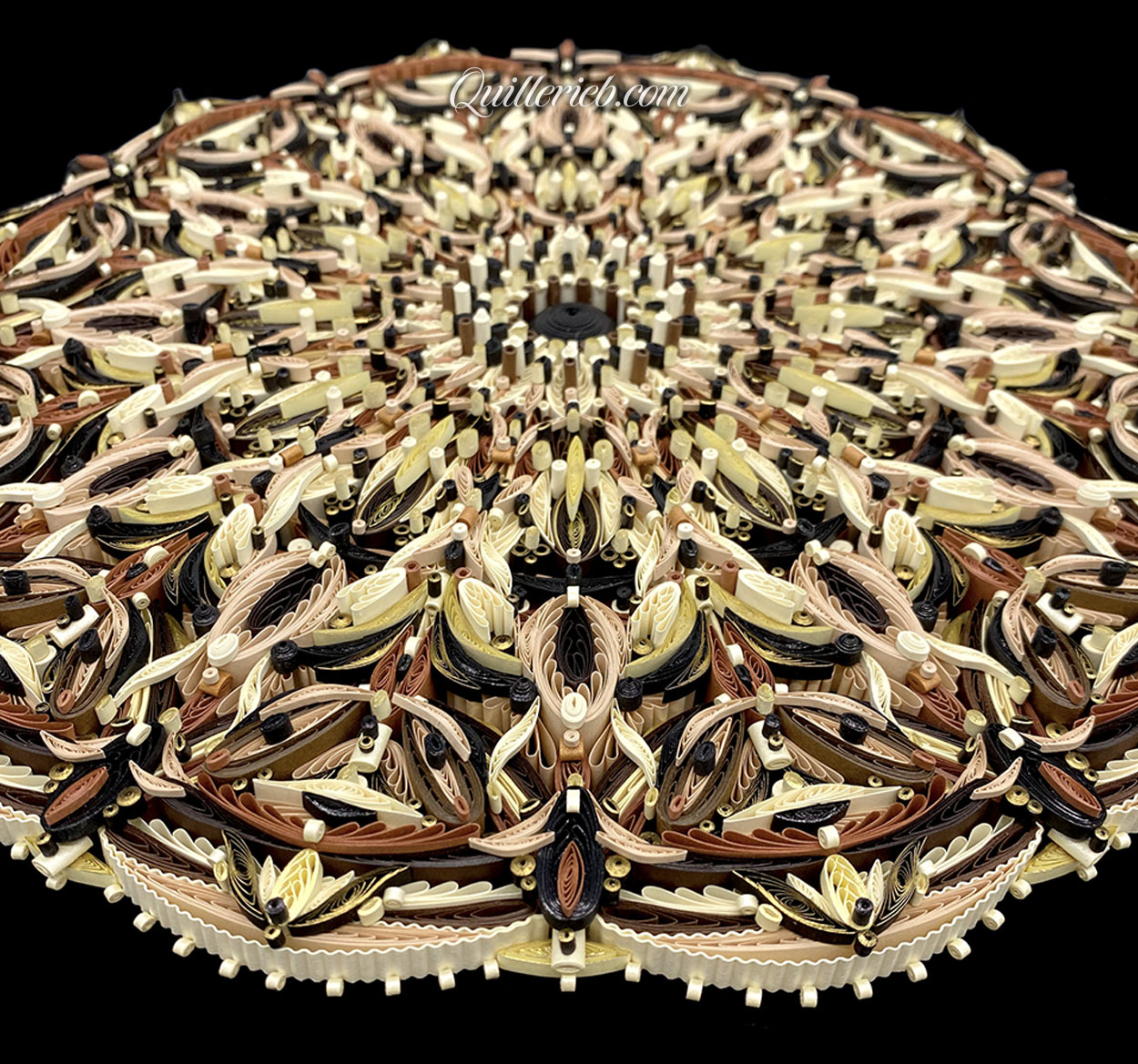 Circular quilled design in brown tones perspective, slanted backwards view.