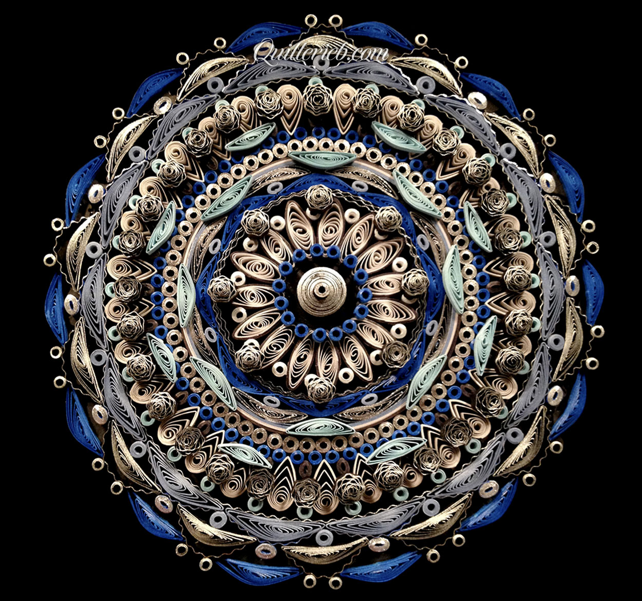 Circular quilled design in muted metallic blue and white color tones full view.
