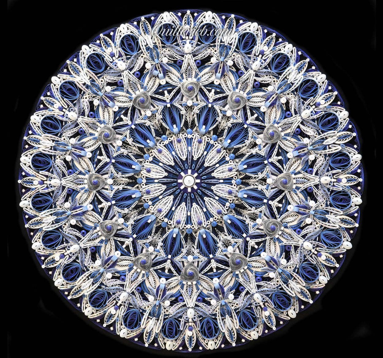 Circular quilling in blue and white colors full view.