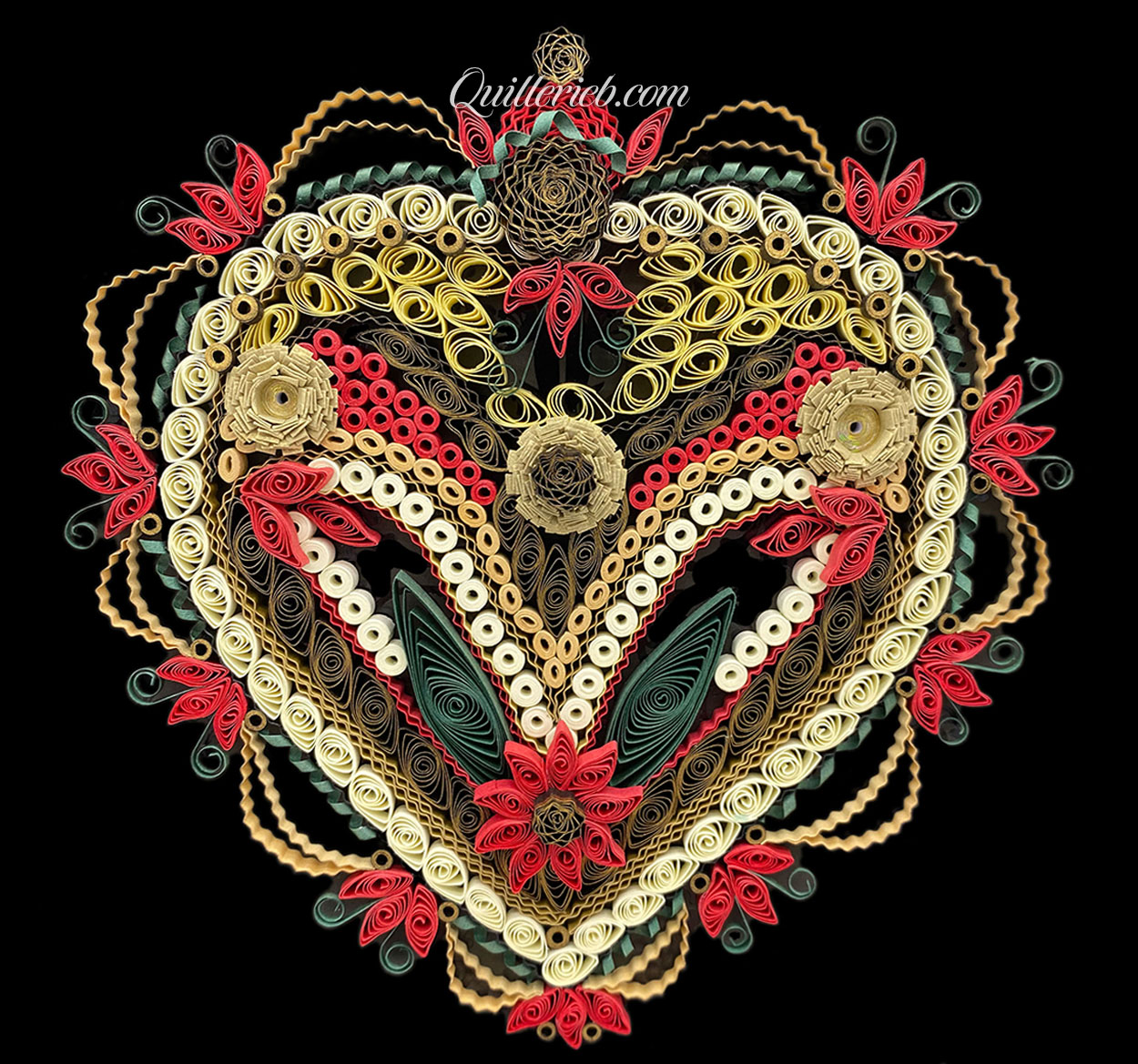 Heart-shaped quilling design in reds, creams, greens and browns full view.