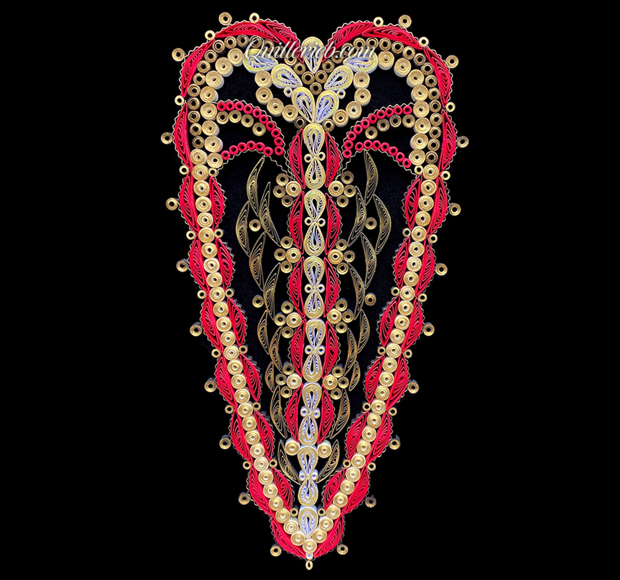 Oblong heart shape quilling in creams and reds full view.