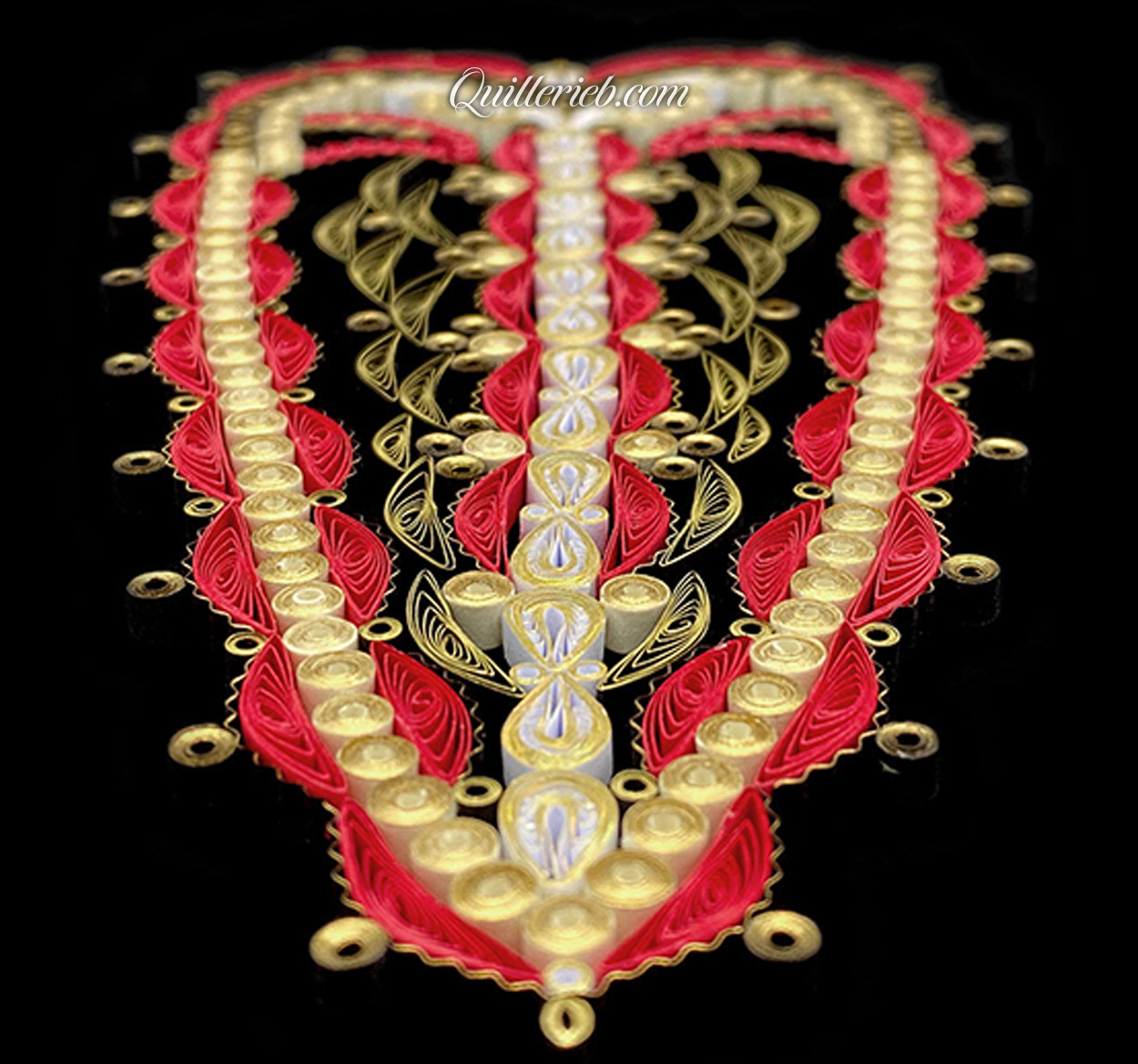 Oblong heart shape quilling in creams and reds perspective slanting backwards view.