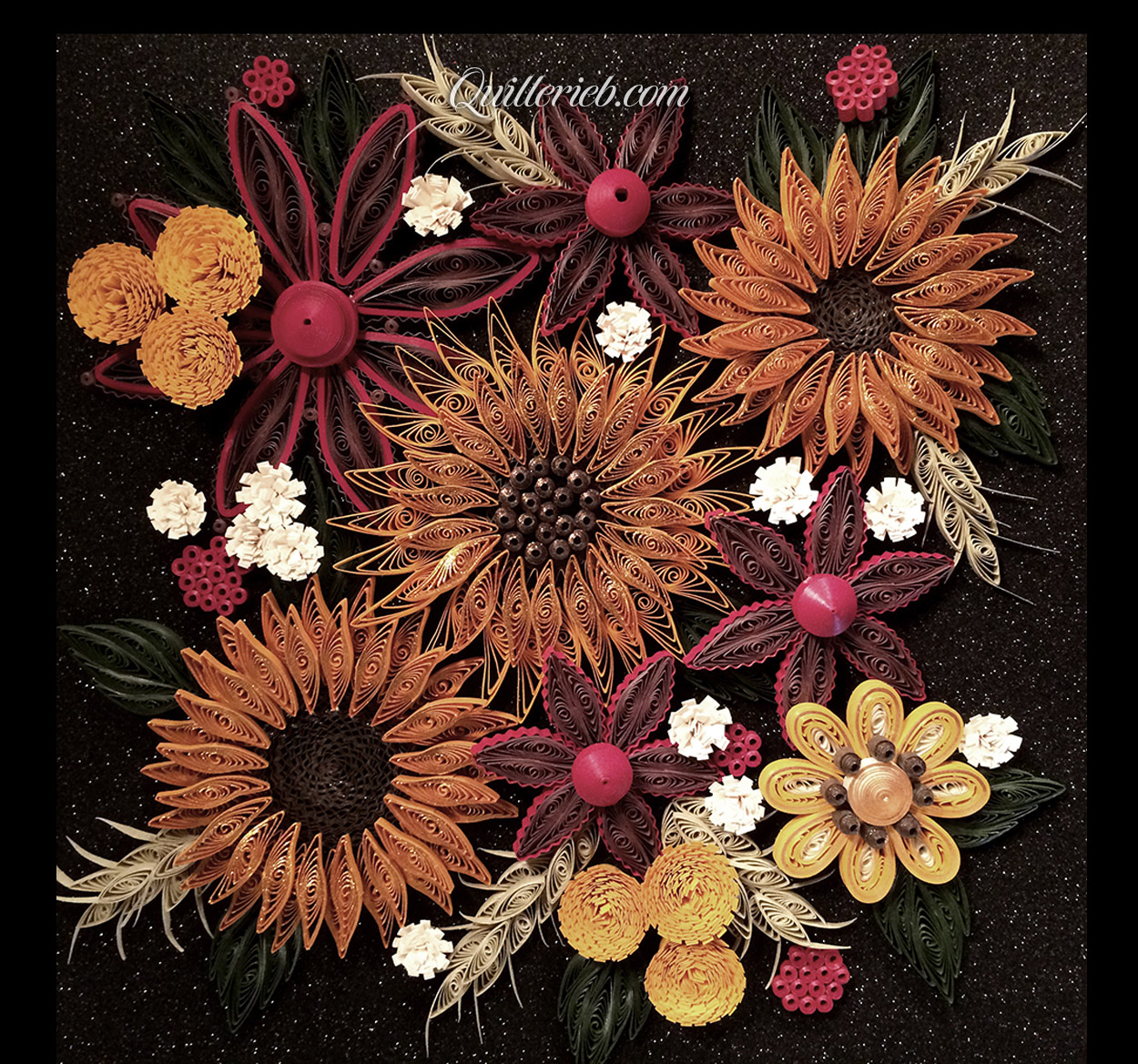 Fall color quilling design, flower shapes on dark background.