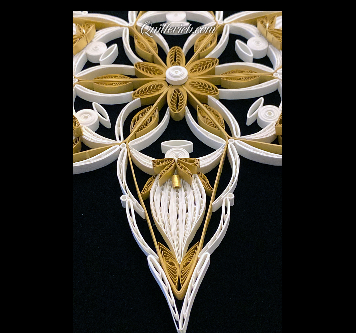 6-Point Star quilling design in white with elements of brown tones bottom close-up angled backwards view.