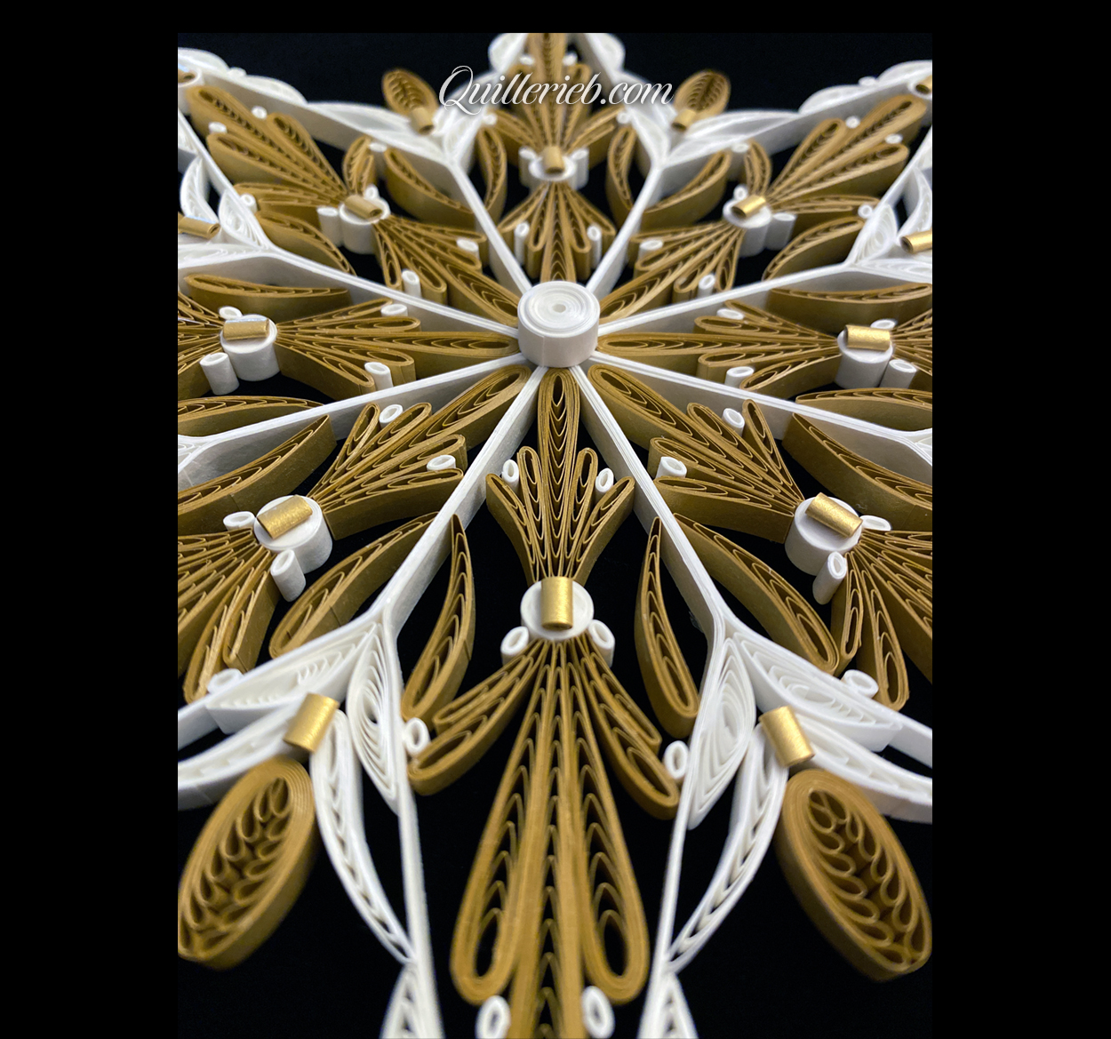 Eight-Point Star quilling design in brown tones and elements of white centered angled backwards view.